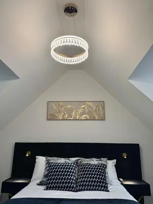 a bedroom with a bed and a ceiling at Park Villa, Stevenage in Shephall