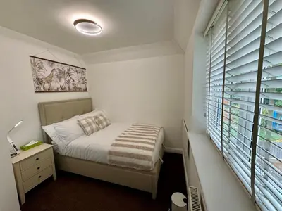 a small bedroom with a bed and a window at Park Villa, Stevenage in Shephall