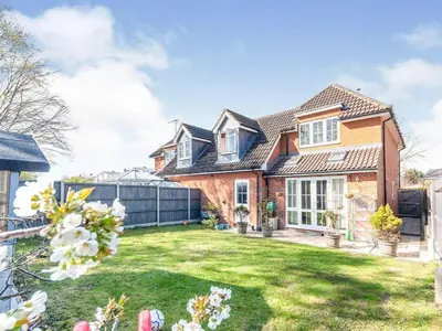a large brick house with a yard at Park Villa, Stevenage in Shephall