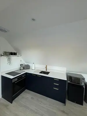 a kitchen with a sink and a stove at The Cartlodge - Studio Loft Apartment in Horringer, Bury St Edmunds in Westley