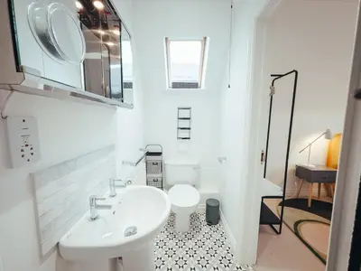 a white bathroom with a sink and a toilet at 5 Bed Family Home- Free Parking in Woodham Ferrers Station