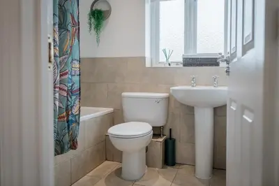 a bathroom with a toilet and a sink at 5 Bed Family Home- Free Parking in Woodham Ferrers Station