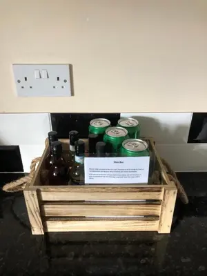 a crate full of beer bottles on a table at Country View place in Weeley