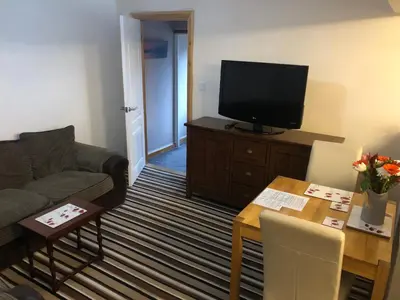 a living room with a couch and a television at Country View place in Weeley