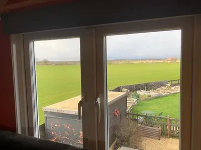 an open door with a view of a green field at Country View place in Weeley