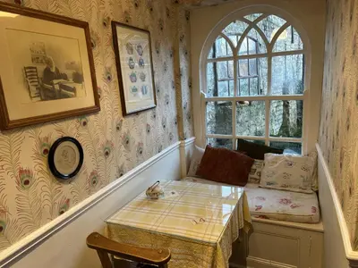 a small room with a table and a window at Peacocks Tearoom and Fine B&B in Ely