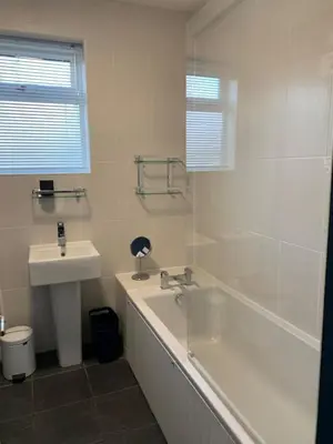 a white bathroom with a sink and a tub and a sink at 3 Bed Family House Free Parking in Southend-on-Sea