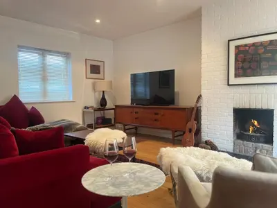 a living room with a couch and a fireplace at Charming Cottage nestled in the heart of a picturesque village in Westleton