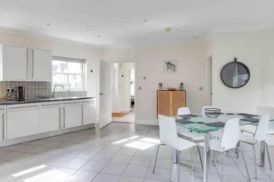 a kitchen and dining room with a table and chairs at Elizabeth Four Bedroom Townhouse in Bocking Churchstreet