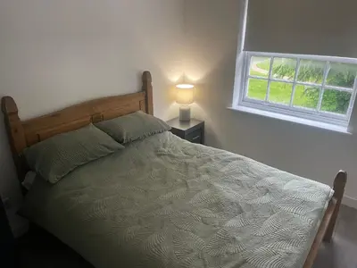 a bedroom with a bed and a window at Priory View in Saint Osyth