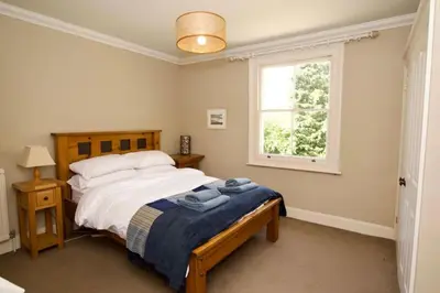 a bedroom with a bed and a window at Beautiful country home and garden in Kirby Cross
