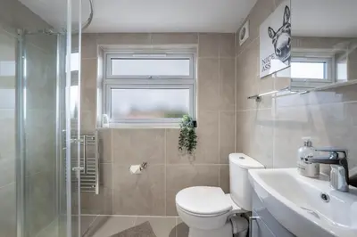 a bathroom with a toilet and a sink and a shower at Newmarket House 5 Bedroom 5 En-suite Free Parking in Newmarket
