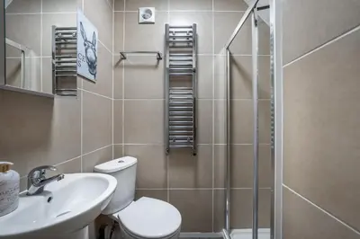 a bathroom with a shower and a toilet and a sink at Newmarket House 5 Bedroom 5 En-suite Free Parking in Newmarket