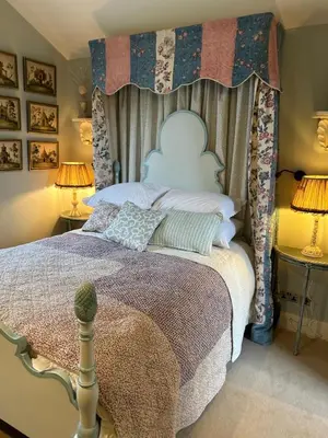a bedroom with a large bed with a canopy at Meesden Hall in Meesden