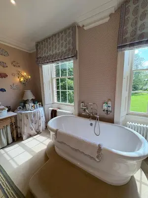a large bathroom with a large tub in a room at Meesden Hall in Meesden