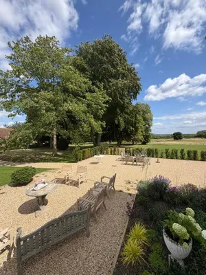 a park with benches and a table and a tree at Meesden Hall in Meesden