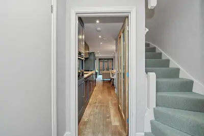 a hallway with stairs leading to a kitchen at 7D Albert St - sleeps 4 guests with parking on request in Bury Saint Edmunds
