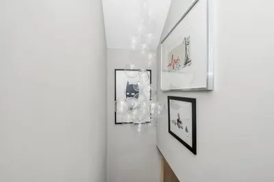 a hallway with a chandelier and pictures on the wall at 7D Albert St - sleeps 4 guests with parking on request in Bury Saint Edmunds