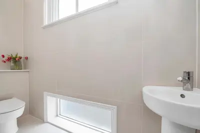 a white bathroom with a sink and a toilet at 7D Albert St - sleeps 4 guests with parking on request in Bury Saint Edmunds