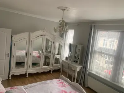 a bedroom with a white dresser and a mirror at Sami in Southend-on-Sea