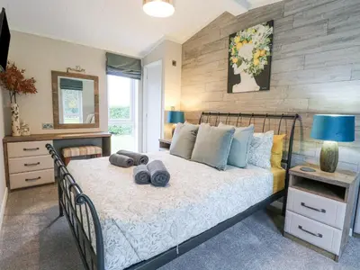 a bedroom with a bed with towels on it at Wurzburc in Swaffham