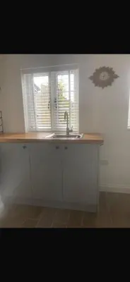 a kitchen counter with a sink and a window at Chestnut Cottage in Great Ellingham