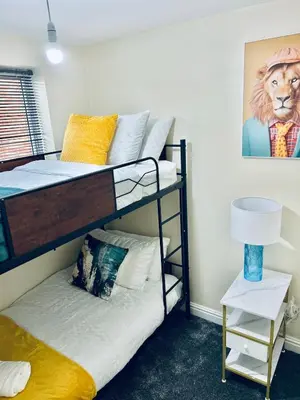 a bedroom with two bunk beds with a lion picture at Spacious 3BR Home in Colchester, with Private Parking in Colchester