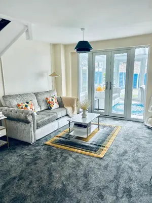 a living room with a couch and a table at Spacious 3BR Home in Colchester, with Private Parking in Colchester