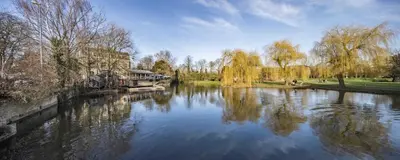a view of a river with a boat on it at Stunning Central Apt With Parking in Cambridge