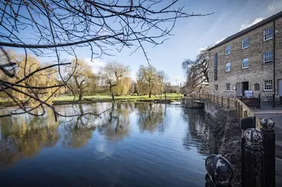 a river in front of a building next to a building at Superb Central Apt River Views & Parking in Cambridge