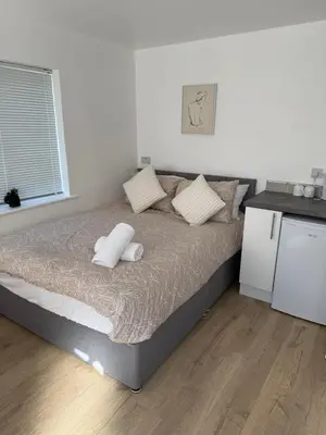 a bed with two pillows on it in a bedroom at Colne cabin in Earls Colne