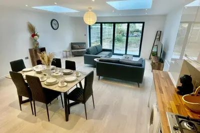 a living room with a table and a couch at 3 Bed Flat - Sleeps 6 - Parking - Wifi in Cambridge