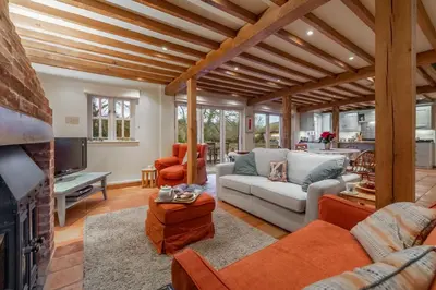 a living room filled with furniture and a fireplace at The Granary, Hacheston 4 in Marlesford