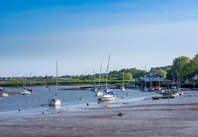 a group of boats sitting in the water at The Shepherds Hut at Anvil House in Woodbridge