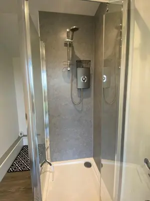 a shower with a glass door in a bathroom at The Old Stable 1 in Messing