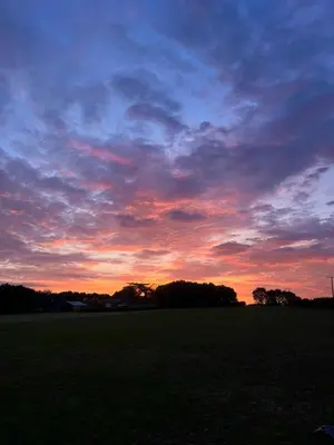 a sunset in a field with a sky at The Old Stable 1 in Messing