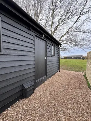 a garage with a door on the side of a house at The Old Stable 1 in Messing