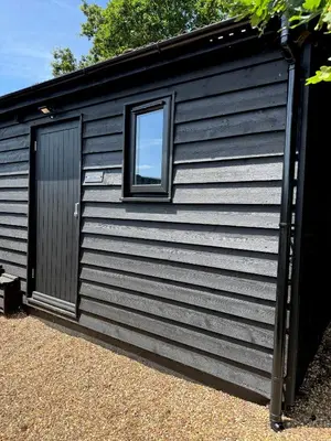 a black shed with a window on the side at The Old Stable 1 in Messing