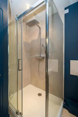 a shower with a glass door in a bathroom at 3 The Coastguards, Thorpeness - Only a stones throw from the Beach and very close to famous boating Meare, Country Club and Golf Club - Aldeburgh Coastal Cottages in Thorpeness