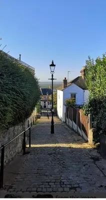 a cobblestone street with a lamp post on a cobblestone street at Leigh On Sea -Broadway-Two Bed with Garden in Southend-on-Sea