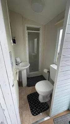 a bathroom with a toilet and a sink at Adventure Van 6 berth St Osyth Beach Park in Saint Osyth