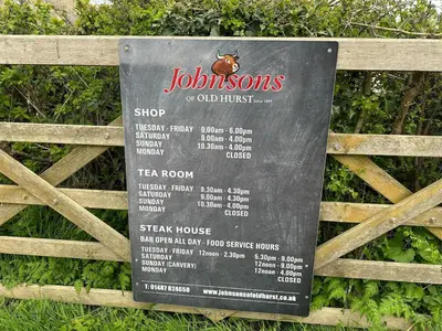 a sign on a fence that says jolensonsshop and old first sign at character filled barn renovation in Old Hurst