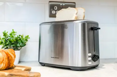 a toaster sitting on a counter with a slice of bread at 2 Bed Elegant home with Parking in Harlow in Harlow