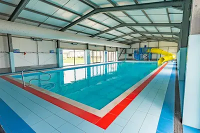 a large swimming pool with a slide in the middle at 3 Bedroom 2 Bathroom Caravan Charlie Delta in Saint Osyth