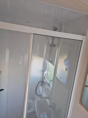 a glass shower with a sink in a bathroom at 3 Bedroom 2 Bathroom Caravan Charlie Delta in Saint Osyth