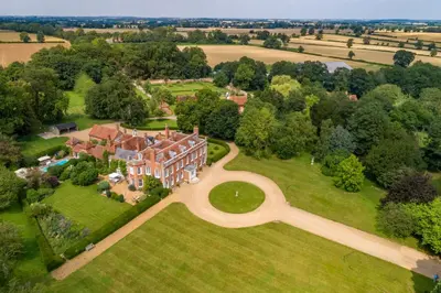 an aerial view of a large house on a lawn at Belchamp Hall Coach House in Belchamp Otten