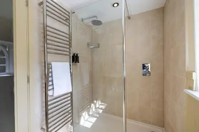a bathroom with a shower with a bath tub at The Cat House in Woolverstone
