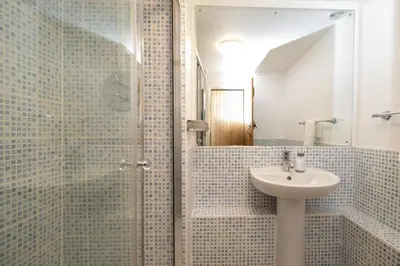a bathroom with a sink and a shower at Emeny Cottage - Aldeburgh Coastal Cottages in Aldeburgh
