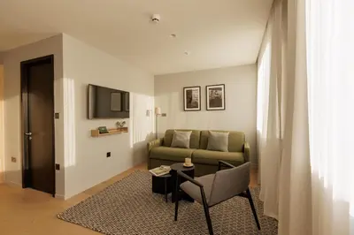 a living room with a couch and a table at Wilde Cambridge City Centre in Cambridge