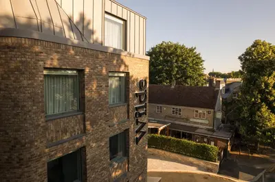 a brick building with a sign on the side of it at Wilde Cambridge City Centre in Cambridge